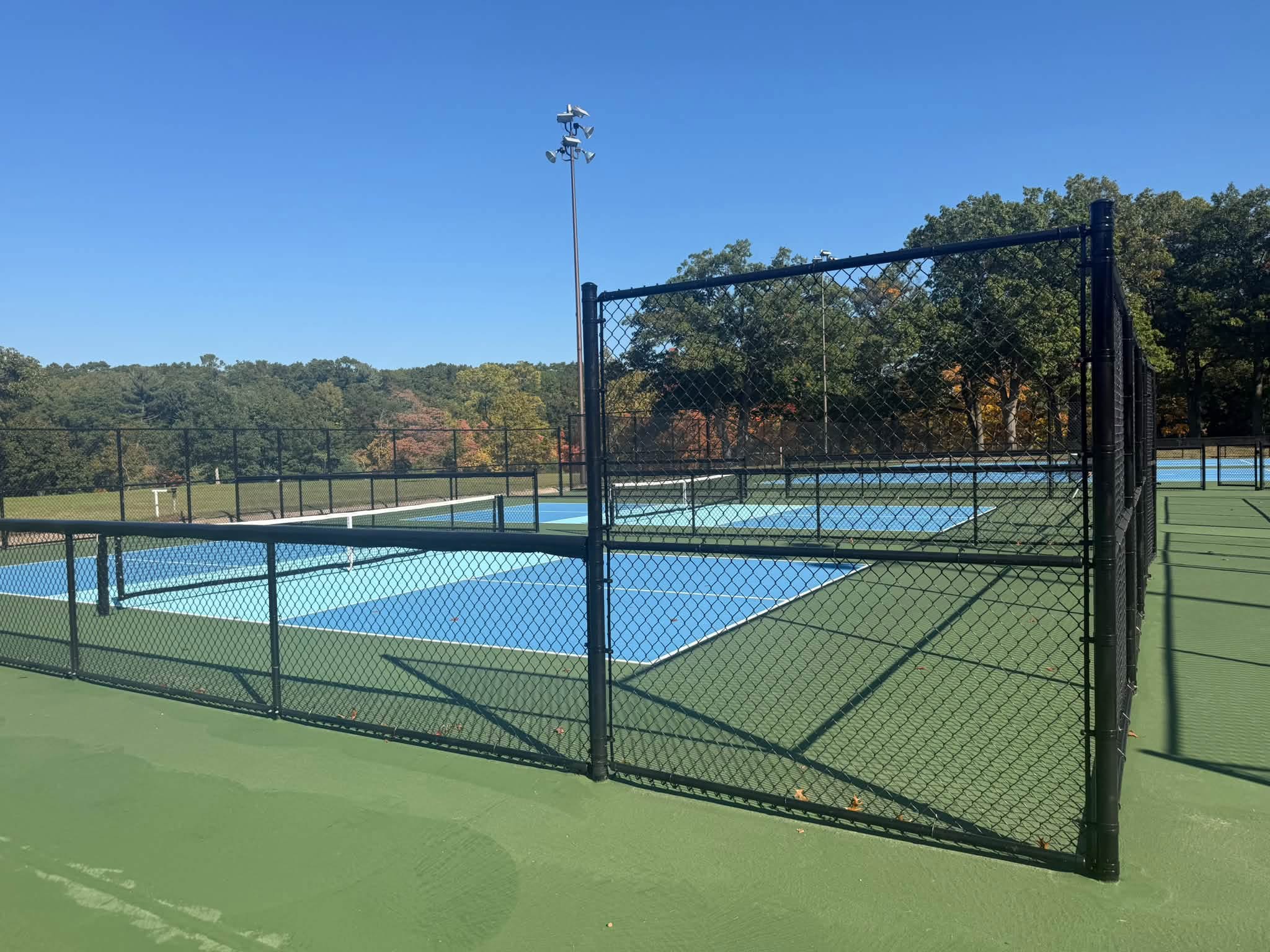 McGraft Park Tennis Court in Muskegon - Black Chain Link Fence tall side
